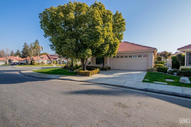 view of front of property with a front yard and a garage