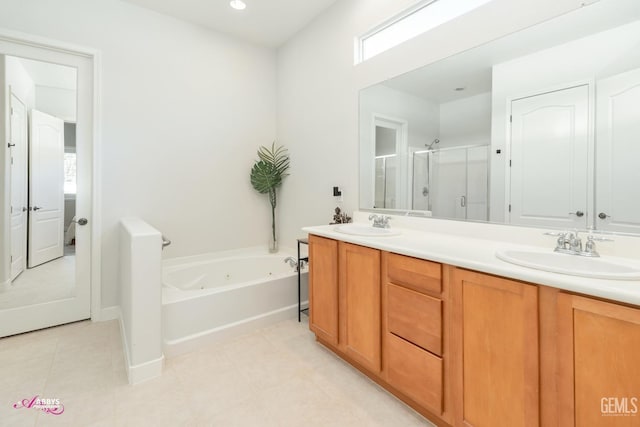 bathroom featuring vanity and independent shower and bath