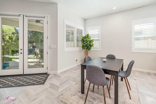 dining space with french doors and light parquet floors