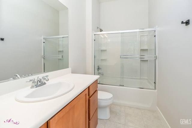 full bathroom with tile patterned flooring, vanity, toilet, and shower / bath combination with glass door