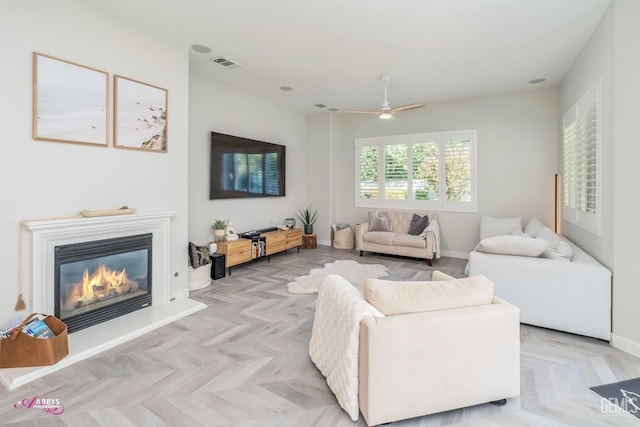 living room with ceiling fan and light parquet flooring