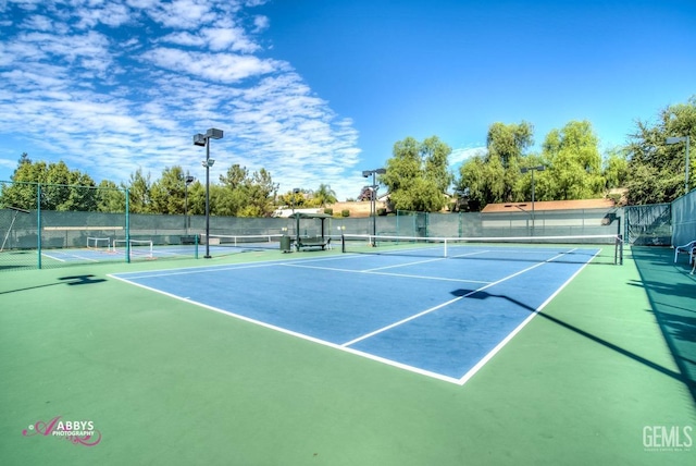 view of tennis court featuring basketball court