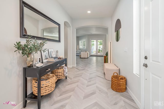 hall featuring french doors and light parquet flooring