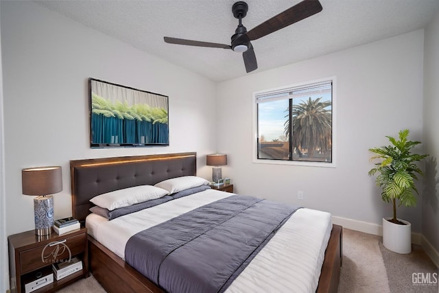 bedroom with ceiling fan, lofted ceiling, carpet flooring, and a textured ceiling