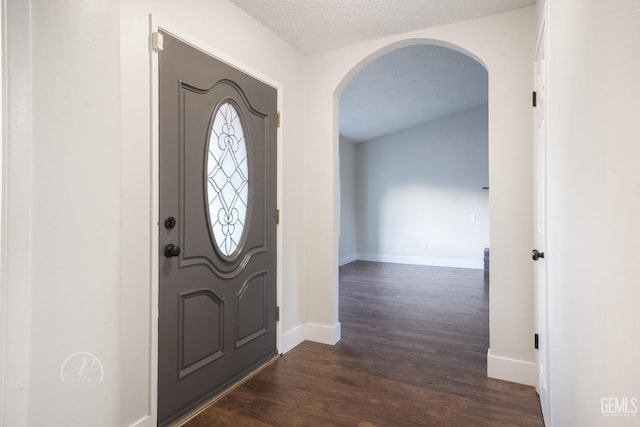 entrance foyer featuring dark hardwood / wood-style flooring and a textured ceiling