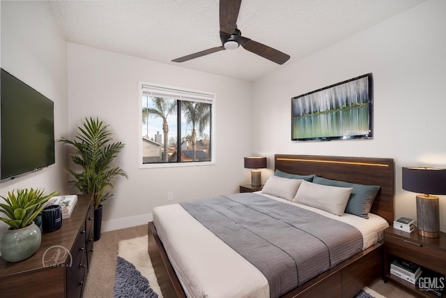 bedroom featuring light carpet, ceiling fan, and a textured ceiling