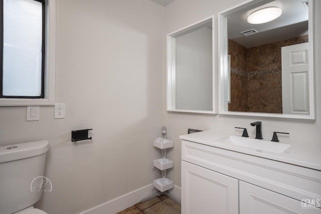 bathroom featuring vanity, tile patterned floors, and toilet