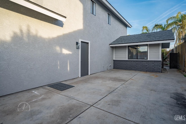 view of side of property with a patio