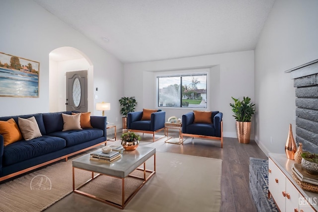 living room featuring vaulted ceiling and dark hardwood / wood-style flooring