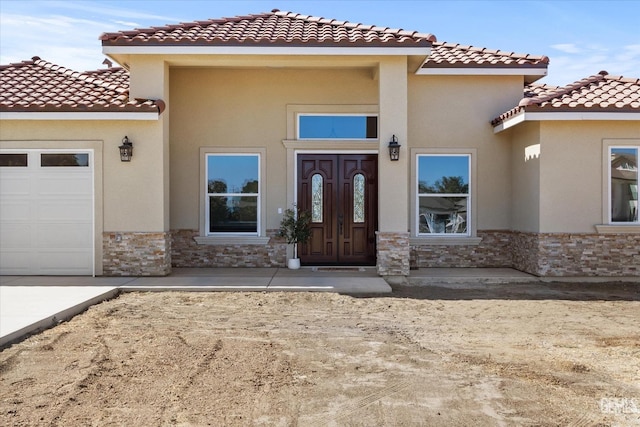 view of exterior entry featuring a garage