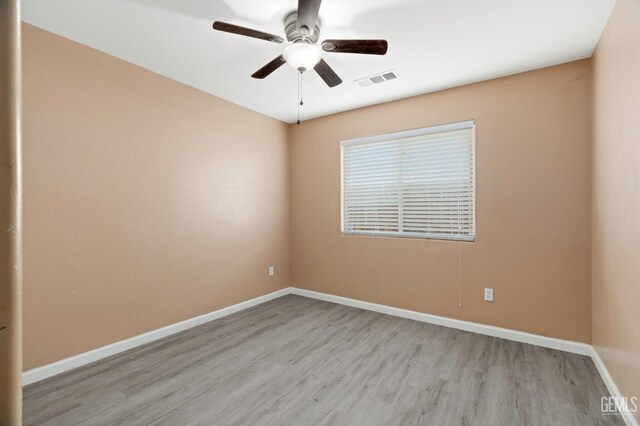 3406 Kimmie Rachelle Ct, Bakersfield, CA 93313 - spare room featuring wood finished floors, a ceiling fan, and baseboards