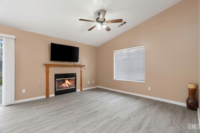 3406 Kimmie Rachelle Ct, Bakersfield, CA 93313 - unfurnished living room with a glass covered fireplace, wood finished floors, vaulted ceiling, a ceiling fan, and baseboards
