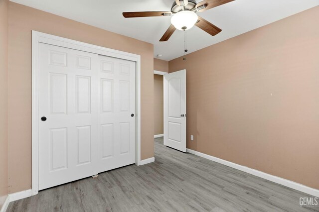 3406 Kimmie Rachelle Ct, Bakersfield, CA 93313 - unfurnished bedroom featuring light wood-type flooring, baseboards, a closet, and a ceiling fan