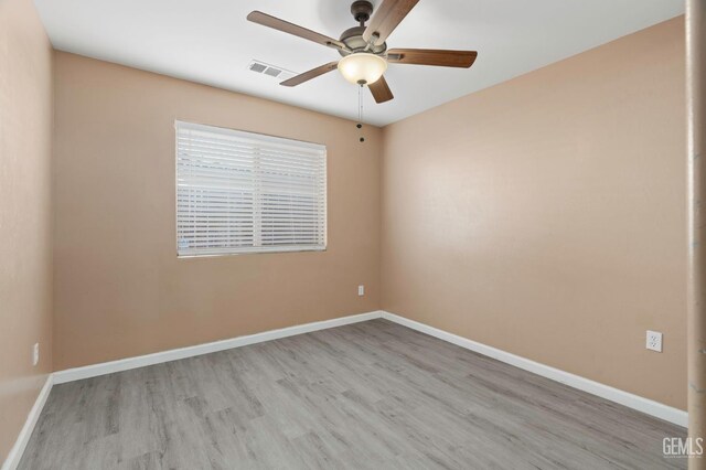 3406 Kimmie Rachelle Ct, Bakersfield, CA 93313 - empty room with ceiling fan, wood finished floors, and baseboards