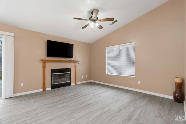 3406 Kimmie Rachelle Ct, Bakersfield, CA 93313 - unfurnished living room featuring wood finished floors, a glass covered fireplace, lofted ceiling, ceiling fan, and baseboards