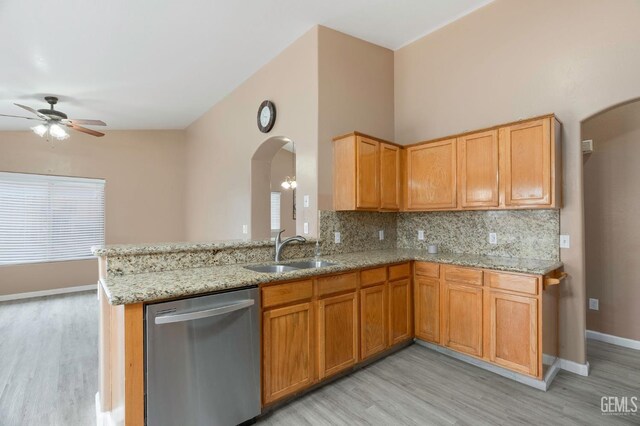 3406 Kimmie Rachelle Ct, Bakersfield, CA 93313 - kitchen featuring dishwasher, a sink, arched walkways, and light wood-type flooring