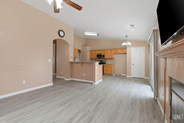 3406 Kimmie Rachelle Ct, Bakersfield, CA 93313 - unfurnished living room featuring lofted ceiling, a ceiling fan, arched walkways, light wood-style flooring, and a chandelier