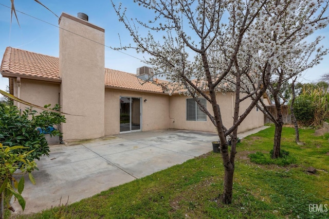 3406 Kimmie Rachelle Ct, Bakersfield, CA 93313 - rear view of house featuring a tile roof, a chimney, stucco siding, and a patio area