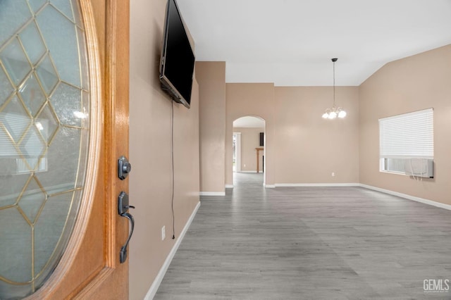 3406 Kimmie Rachelle Ct, Bakersfield, CA 93313 - foyer entrance with arched walkways, wood finished floors, a chandelier, baseboards, and vaulted ceiling