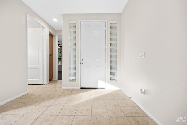 tiled foyer entrance featuring ceiling fan