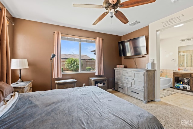 9803 Swansboro Way, Bakersfield, CA 93314 - bedroom featuring carpet, connected bathroom, a ceiling fan, and tile patterned floors