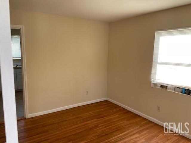 spare room with dark wood-type flooring