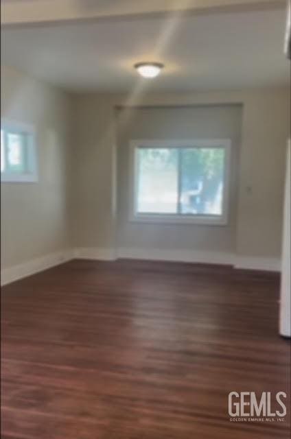 unfurnished room with dark hardwood / wood-style floors