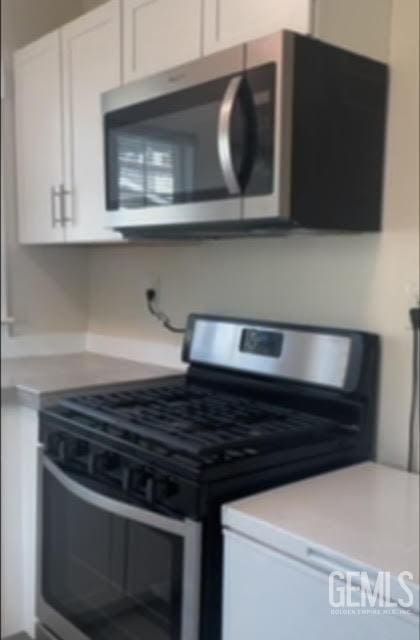 kitchen with white cabinetry and appliances with stainless steel finishes