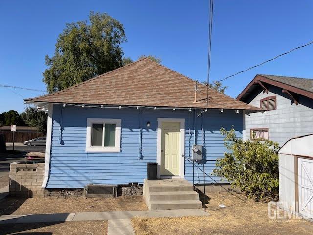 back of property with a shed