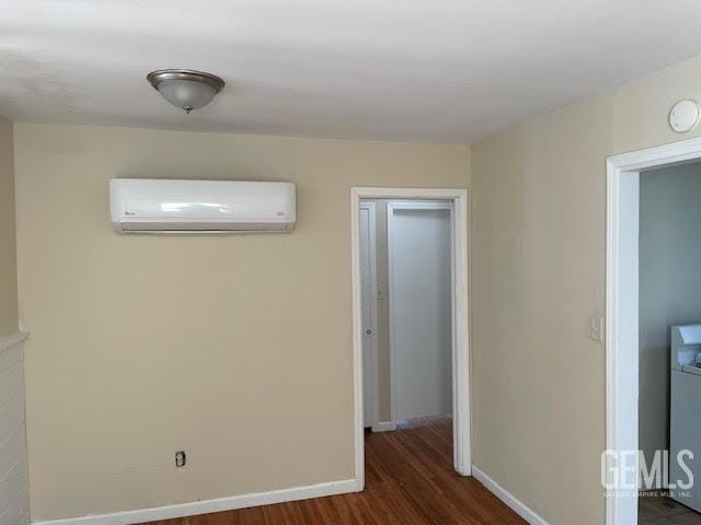 interior space featuring a wall mounted AC and dark wood-type flooring