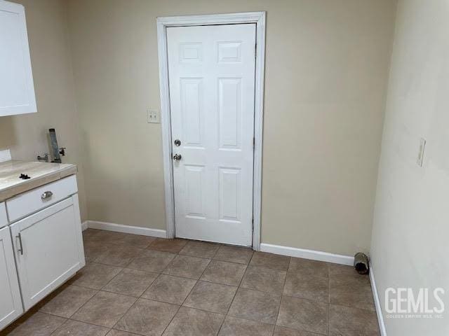 laundry area with cabinets