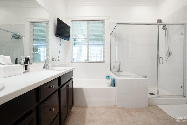 bathroom featuring tile patterned flooring, vanity, plenty of natural light, a shower stall, and a garden tub