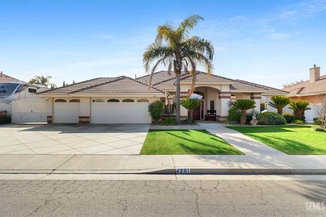 view of front of home featuring a garage and a front lawn