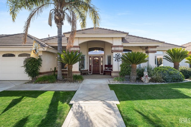 view of front of house with a garage and a front yard