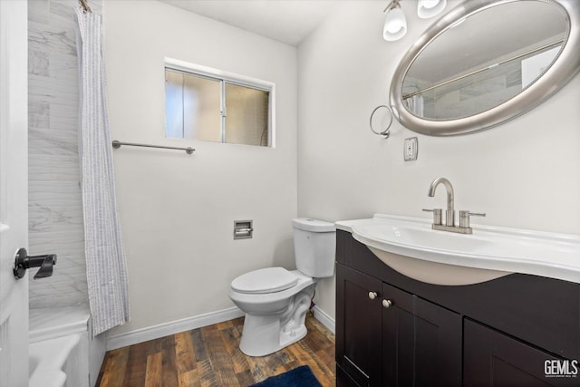 bathroom with hardwood / wood-style floors, vanity, and toilet