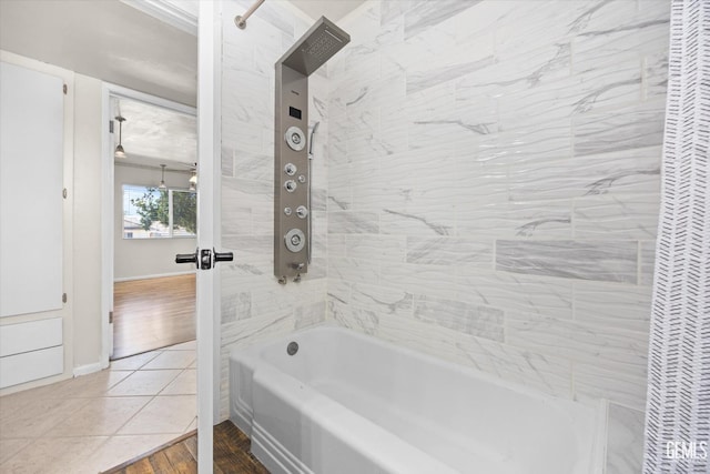 bathroom featuring tile patterned floors and tiled shower / bath