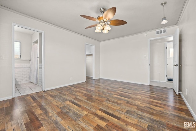 unfurnished room featuring ceiling fan, dark hardwood / wood-style flooring, and crown molding