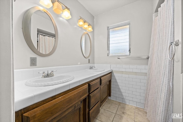 bathroom featuring tile patterned floors, vanity, and tile walls