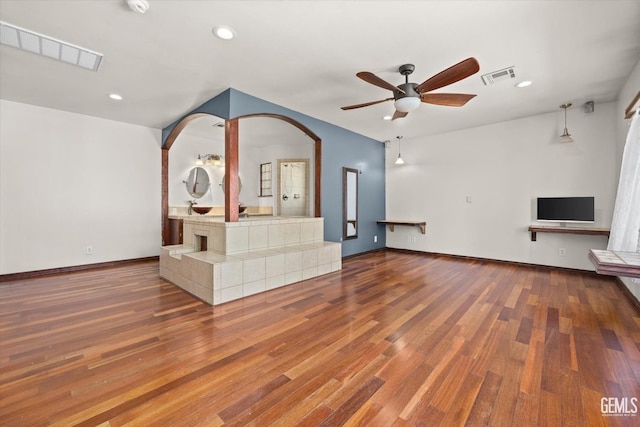 unfurnished living room with hardwood / wood-style floors and ceiling fan