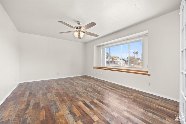 empty room with ceiling fan and dark wood-type flooring