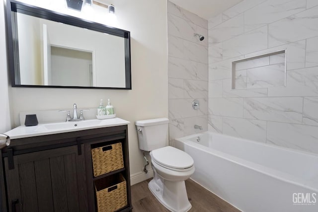 full bathroom featuring hardwood / wood-style floors, vanity, toilet, and tiled shower / bath