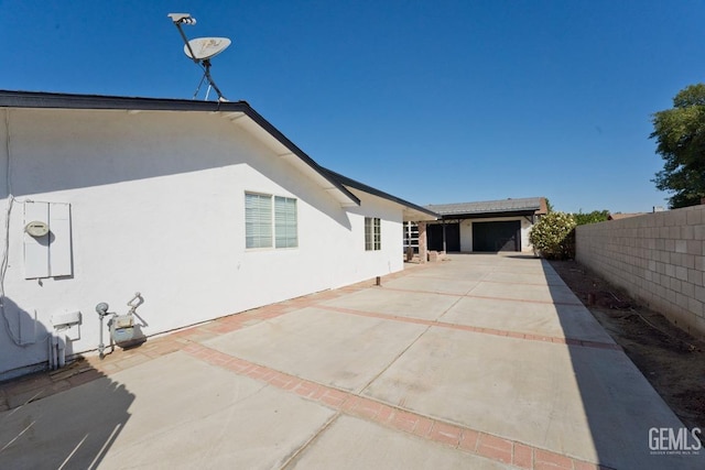 view of side of home with a patio area