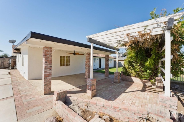 view of patio featuring ceiling fan and a pergola