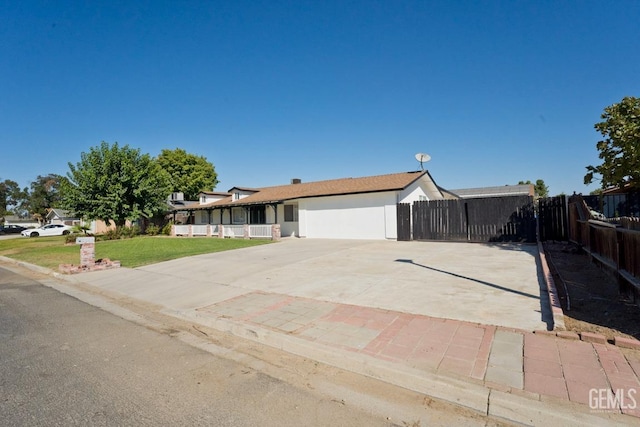 single story home featuring a front yard and a garage