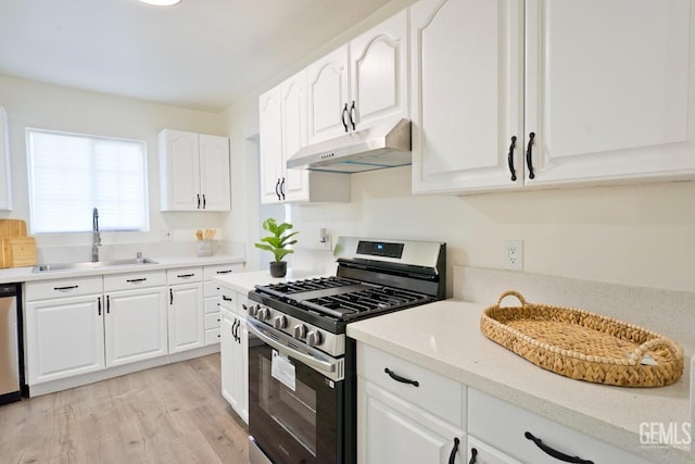 kitchen featuring sink, white cabinetry, stainless steel appliances, and light wood-type flooring