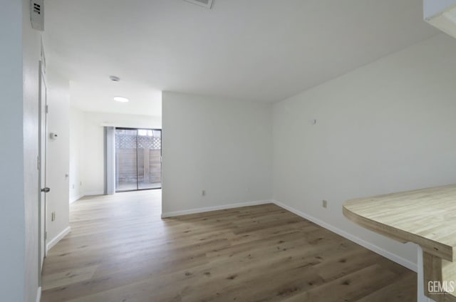 unfurnished room with hardwood / wood-style flooring