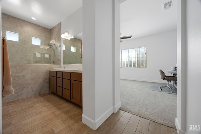 9003 Del Palma Dr, Bakersfield, CA 93314 - full bathroom featuring healthy amount of natural light, wood finished floors, vanity, and walk in shower