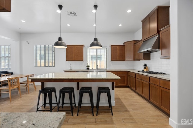 9003 Del Palma Dr, Bakersfield, CA 93314 - kitchen with range hood, light wood-style floors, tasteful backsplash, a kitchen island, and recessed lighting