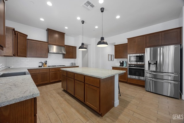 9003 Del Palma Dr, Bakersfield, CA 93314 - kitchen with appliances with stainless steel finishes, ventilation hood, a kitchen island, tasteful backsplash, and decorative light fixtures