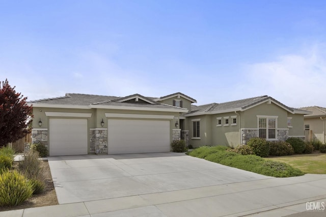 9003 Del Palma Dr, Bakersfield, CA 93314 - view of front of property featuring stone siding, stucco siding, a garage, and driveway